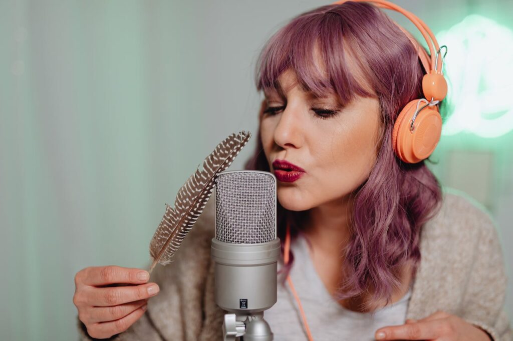 An image showing a women using a feather on a microphone, making ASMR sounds. This helps readers understand ASMR and learn it's impact on mental health.