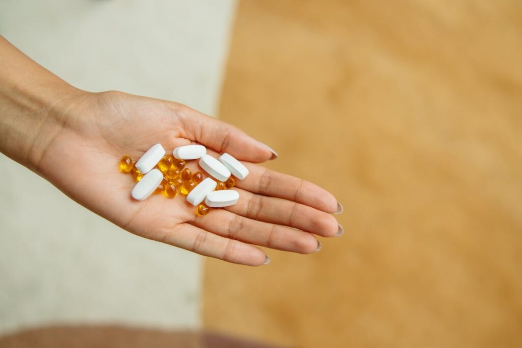 Image of magnesium pills in someones hand, part of the article on Biohack Insider about choosing the right magnesium supplement.