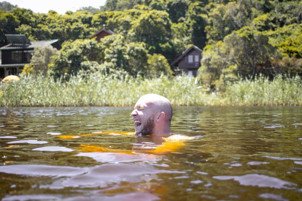 A man cold plunging in a lake